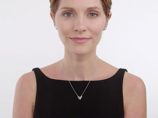Woman wearing a delicate diamond bow necklace