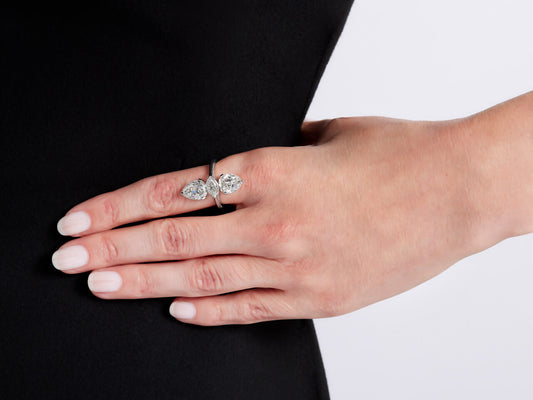 Hand wearing a platinum ring with three diamonds