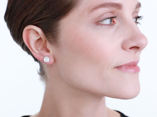 Woman wearing a white gold diamond halo stud earring
