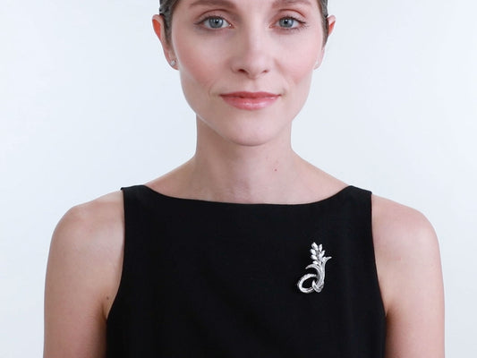 Woman wearing a platinum diamond flower brooch