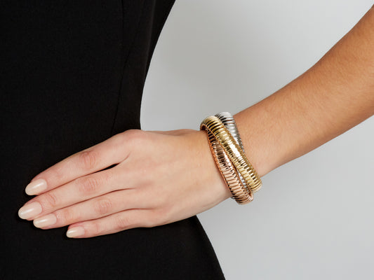Three interlocking tubogas bracelets in yellow white and rose gold