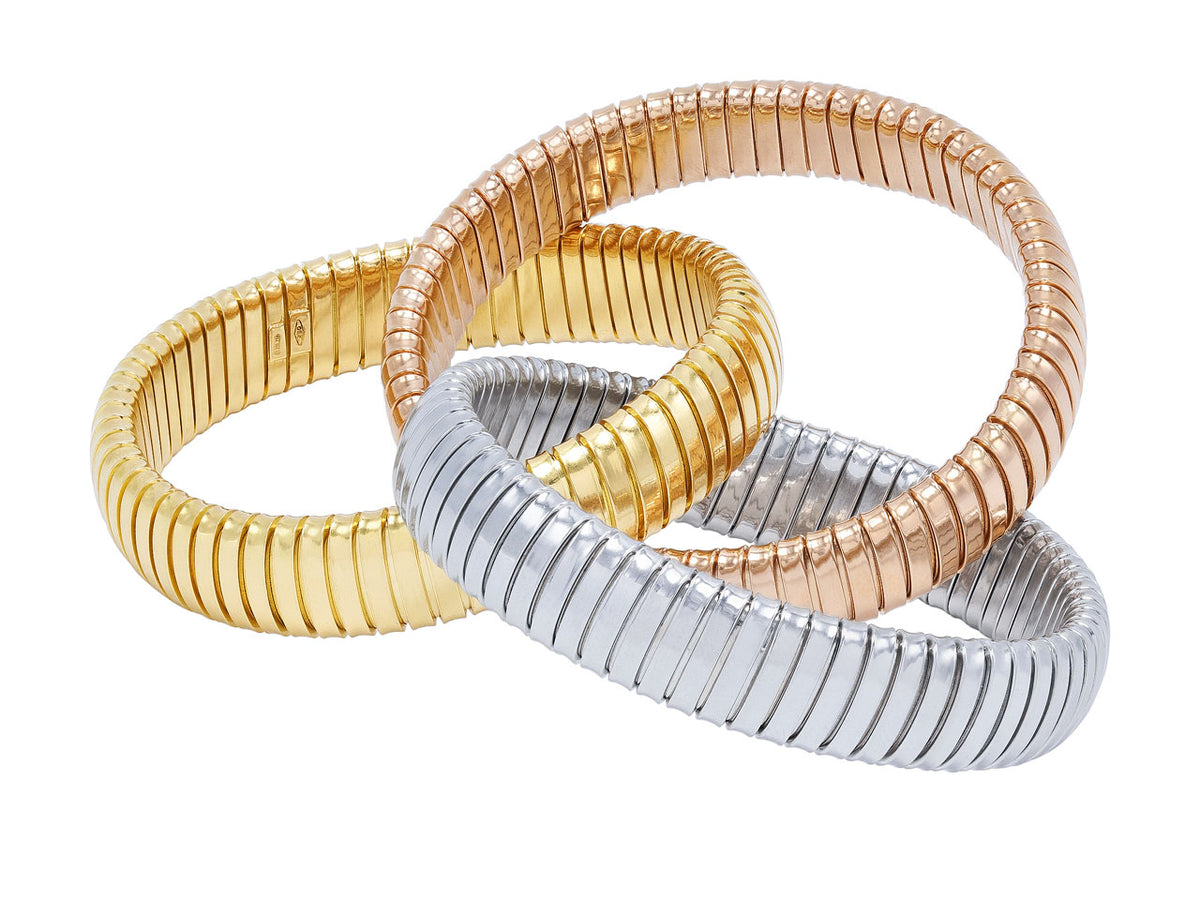 Three interlocking tubogas bracelets in 18K yellow white and rose gold