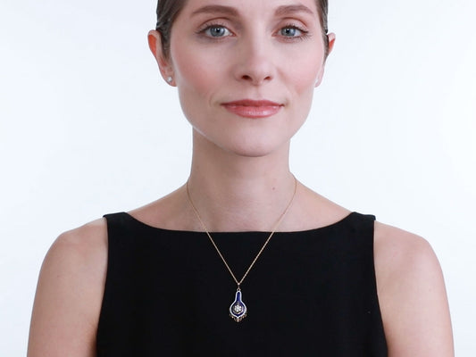 Model wearing a blue enamel and diamond pendant