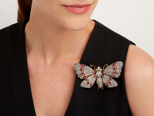 Ruby and diamond butterfly brooch worn on black dress