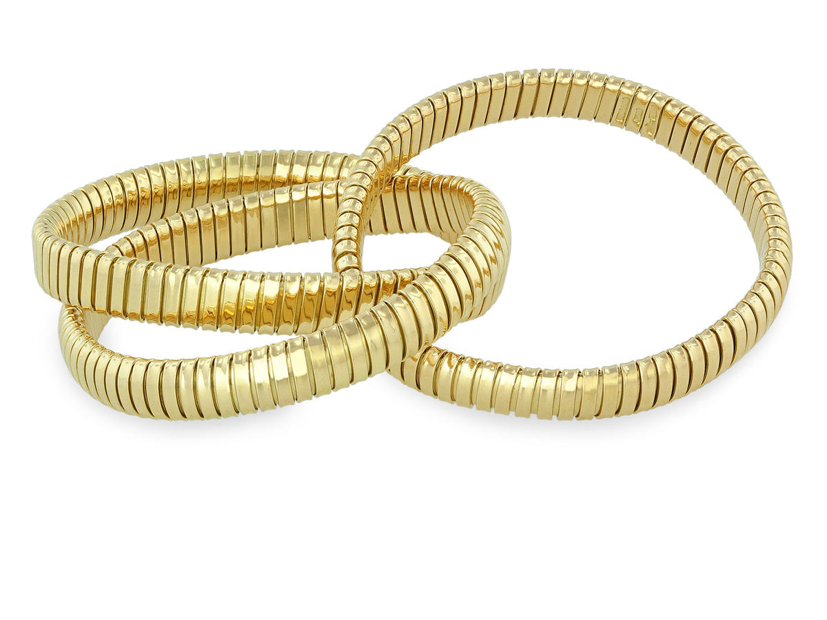 Three interlocking 18K yellow gold tubogas bracelets