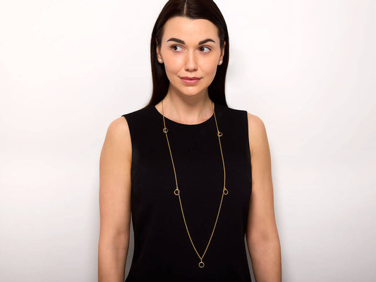 Model wearing a Cartier Trinity gold station necklace