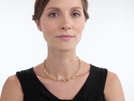 Woman wearing a gold choker chain necklace