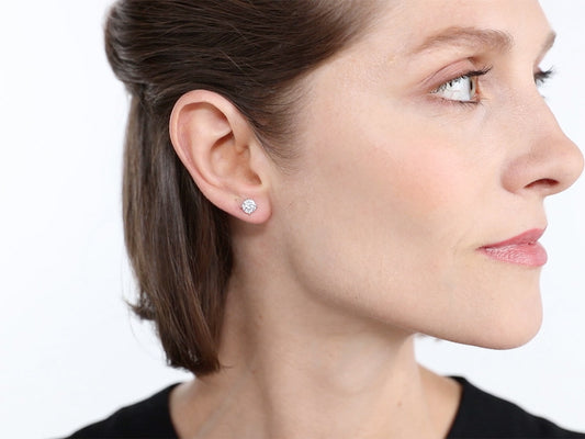 Side profile of woman wearing a diamond stud earring