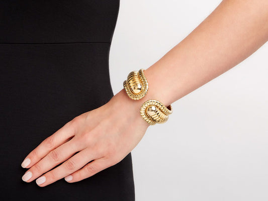18K yellow gold domed cuff bracelet worn on wrist