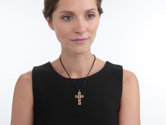 Woman wearing a rose gold diamond cross pendant