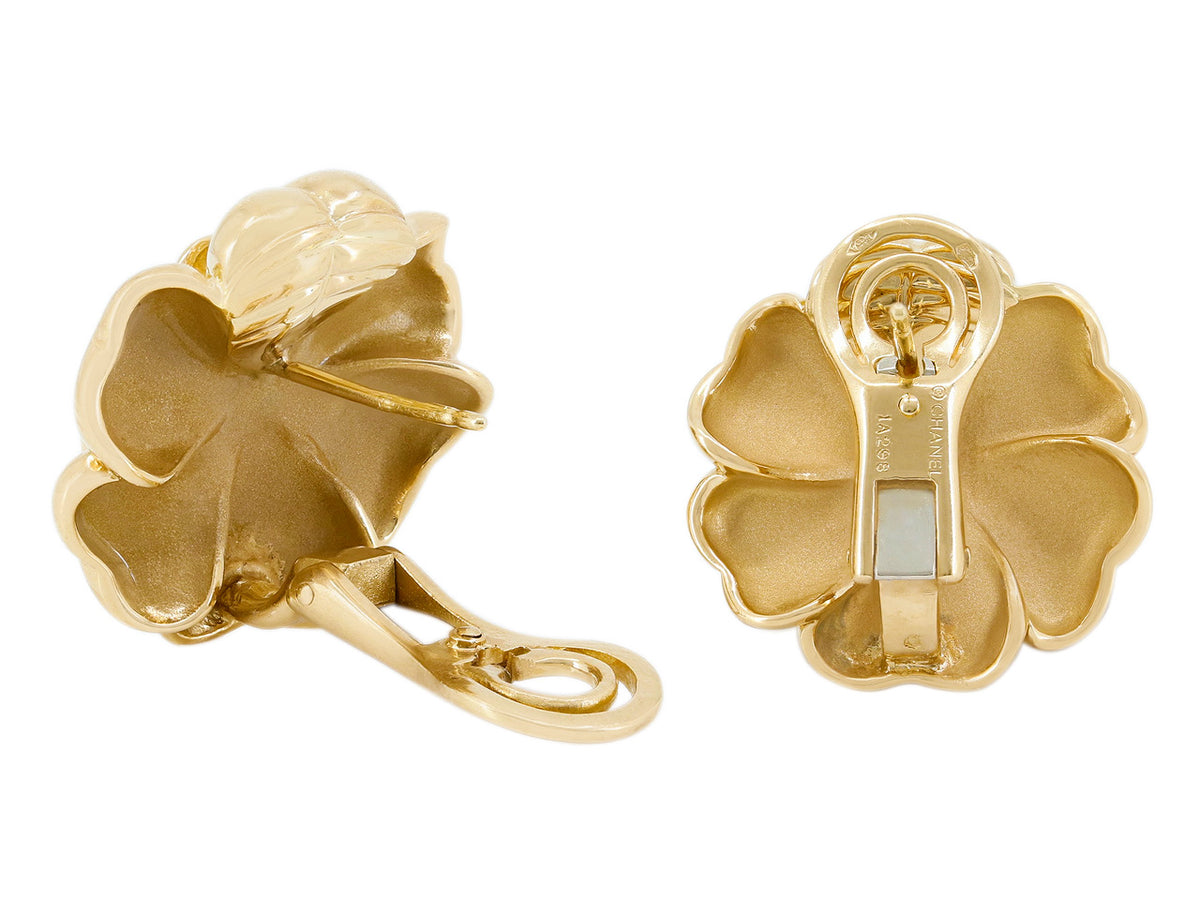 Back view of gold floral earrings with clipback closures
