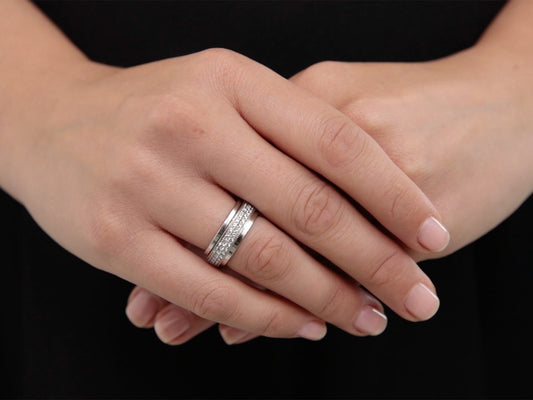 Hands wearing a two row pave diamond band in white gold
