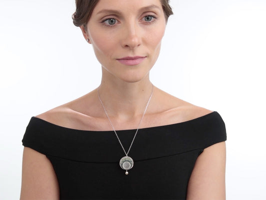 Woman wearing an Art Nouveau diamond and pearl pendant