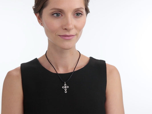 Woman wearing a white gold diamond cross pendant
