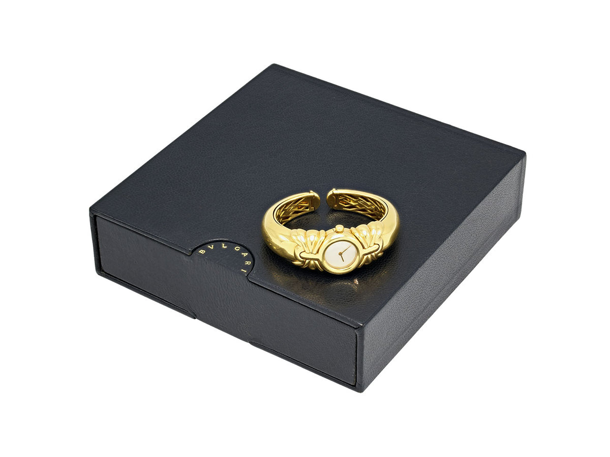 Gold Bulgari watch with open bracelet on black box