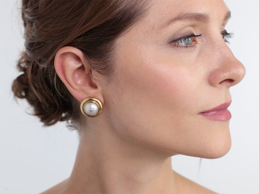 Woman wearing a gold mabe pearl earring
