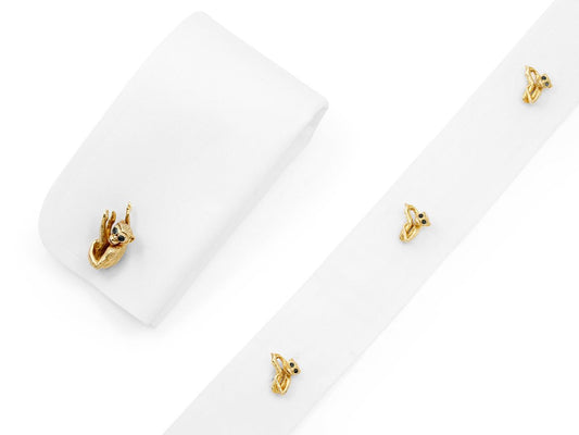 White shirt cuff with 18K gold monkey cufflink and studs