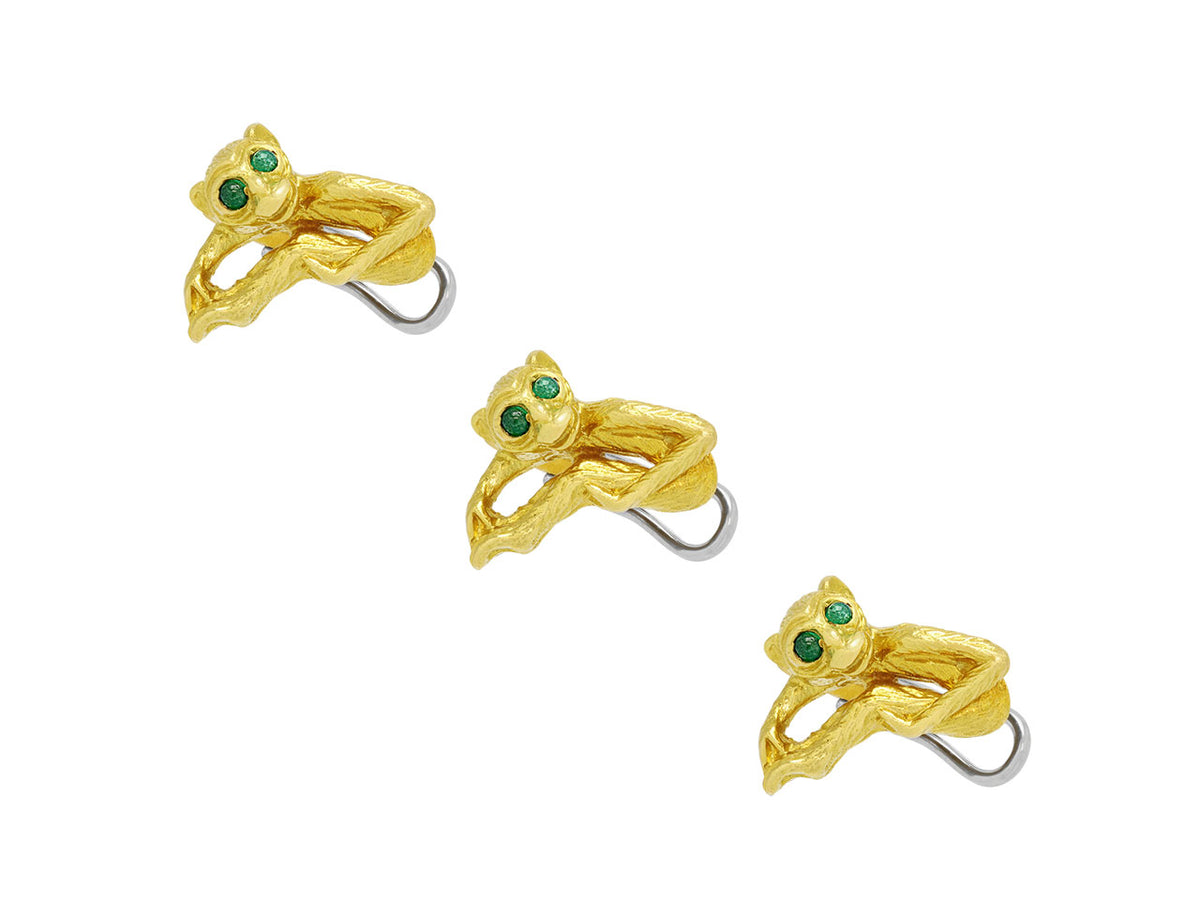 Three gold monkey shirt studs with emerald eyes