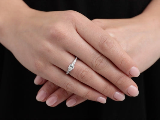 Hand wearing a white gold princess cut diamond ring