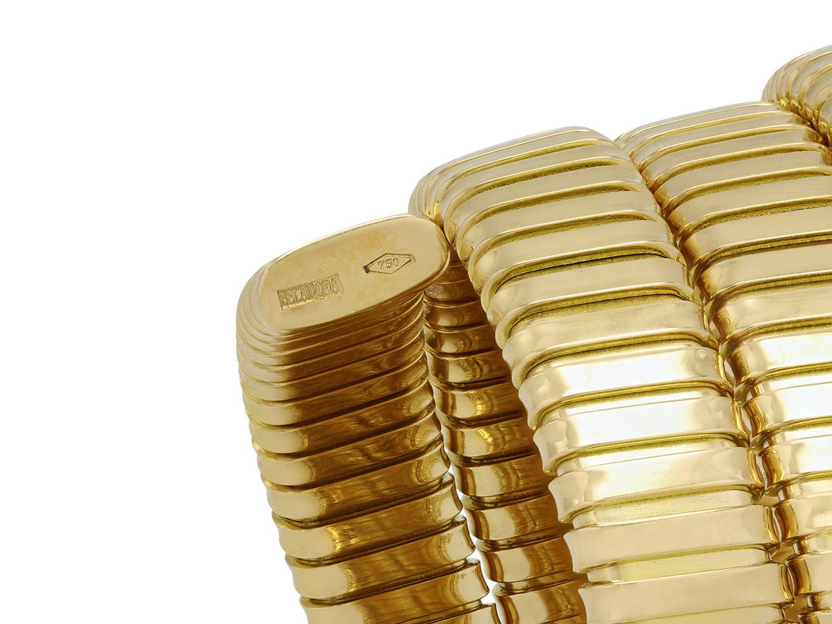 Close up of an Italian triple coil bracelet in 18K gold