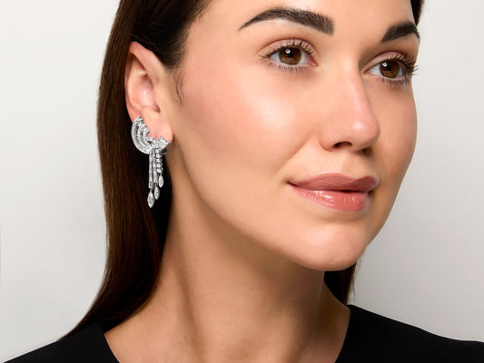 Model wearing a platinum diamond dangle earring