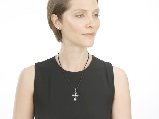 Woman wearing a diamond cross pendant necklace