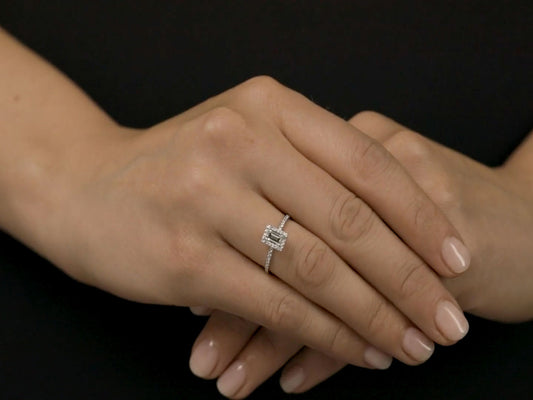 Hands wearing an 18K white gold baguette diamond ring