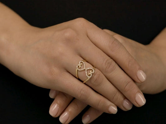 Two heart diamond ring in 18K yellow gold worn on hand