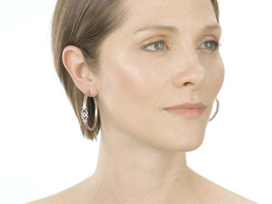 Model wearing textured 18K white gold hoop earrings