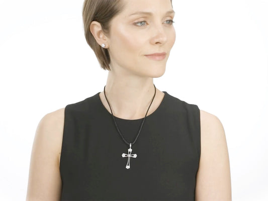 Woman wearing a white gold diamond filigree cross pendant