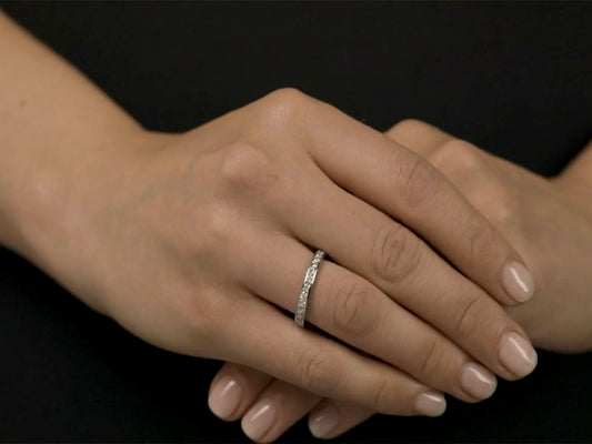 Platinum diamond eternity band worn on folded hands