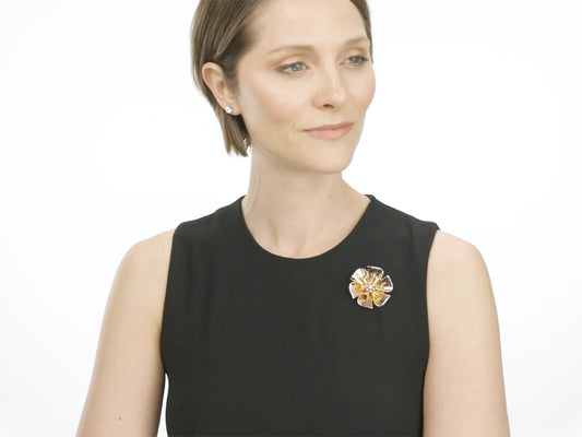 Woman wearing a rose gold floral diamond brooch