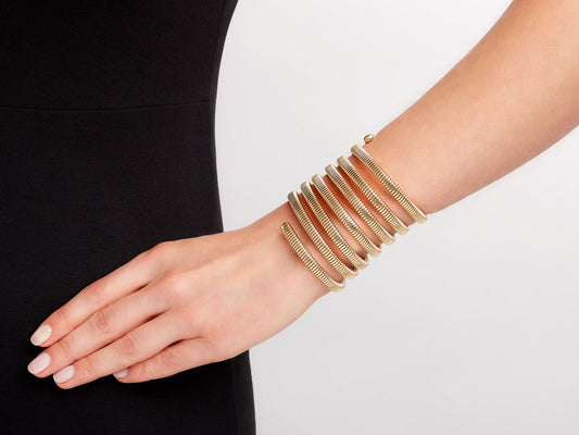 Seven row high polish 18k gold wrap bracelet on wrist