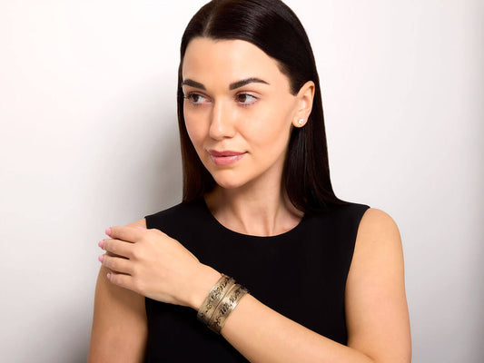 Woman wearing antique Victorian enameled gold bangles