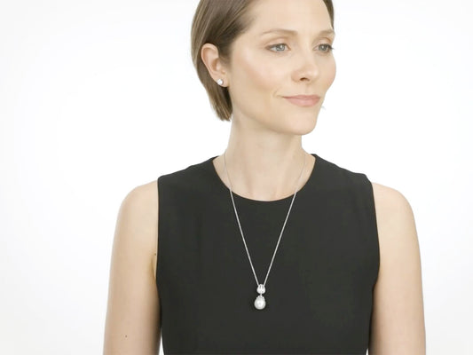 Woman wearing a pearl and diamond pendant necklace in white gold