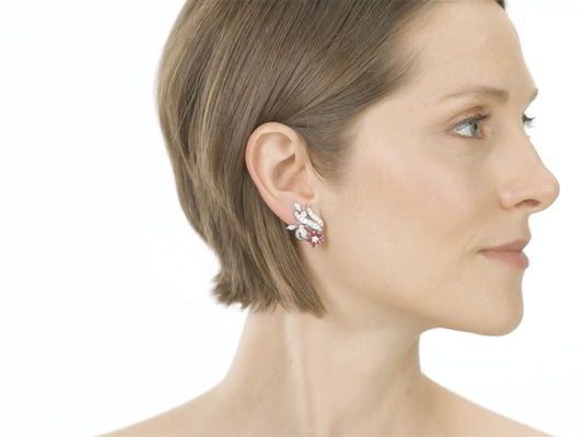 Woman wearing a platinum ruby and diamond flower earring