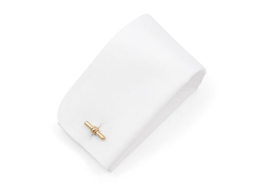 Gold baton cufflink on a white display cushion