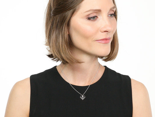 Woman wearing a white gold diamond heart pendant