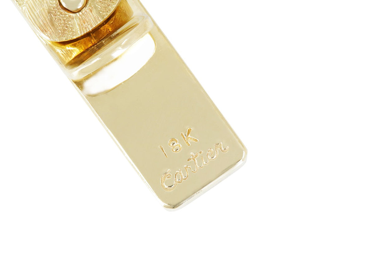 Close up of brushed 18K gold Cartier tie bar