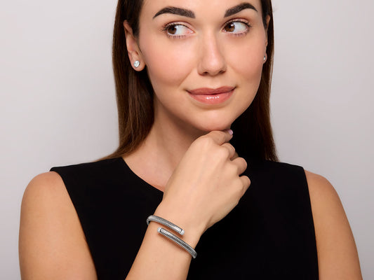 Woman wearing an 18K white gold tubogas diamond bypass bracelet