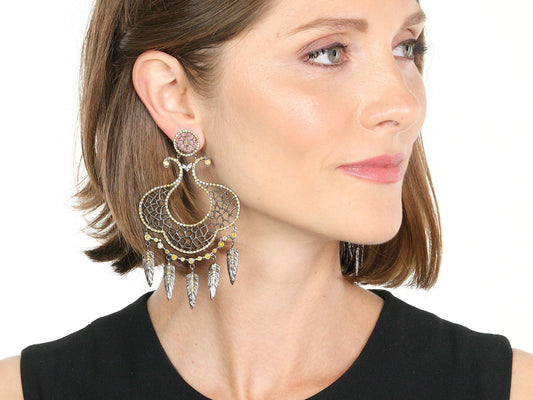 Woman wearing blackened gold dreamcatcher earrings