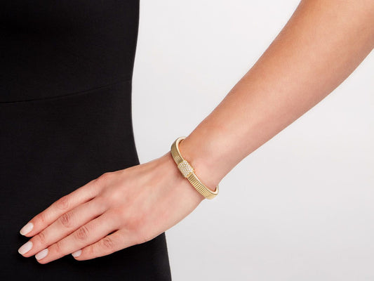 Gold tubogas bracelet with diamond clasp on wrist