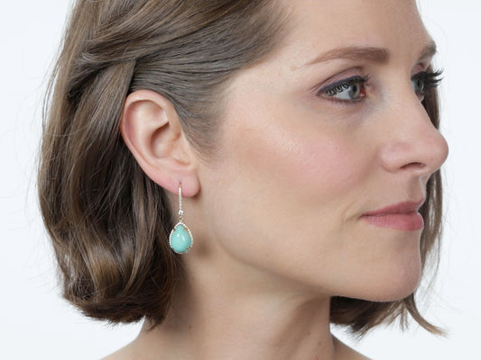 Profile view of a turquoise and diamond drop earring