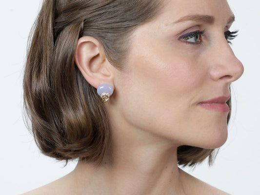 Woman wearing a pale blue chalcedony earring in yellow gold