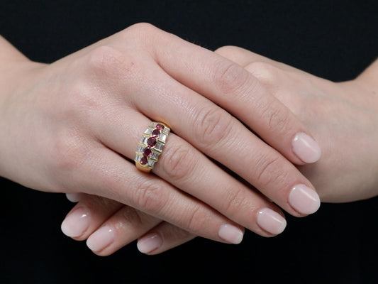 Hand wearing an 18K gold ruby and diamond ring