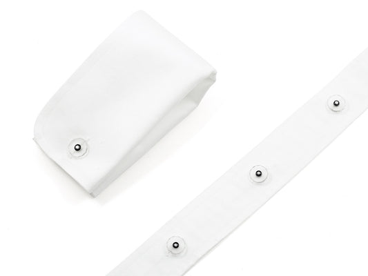 White shirt cuff and placket with three dress studs