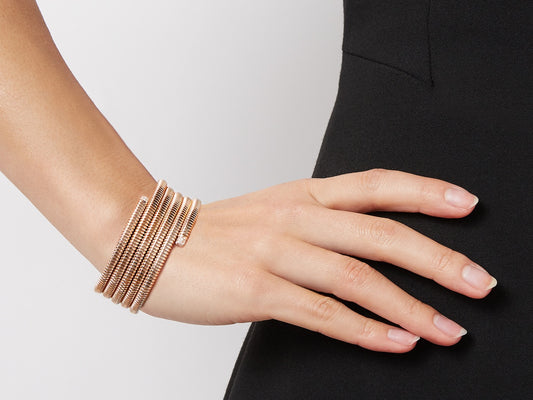Five row rose gold tubogas wrap bracelet worn on wrist