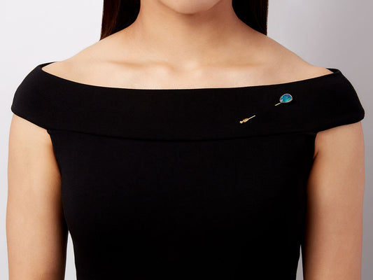 Black opal stick pin worn on a black dress