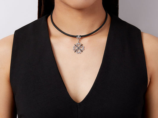 Quatrefoil diamond pendant on a black cord