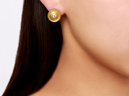 Round hammered 24K gold earring with a bezel set diamond